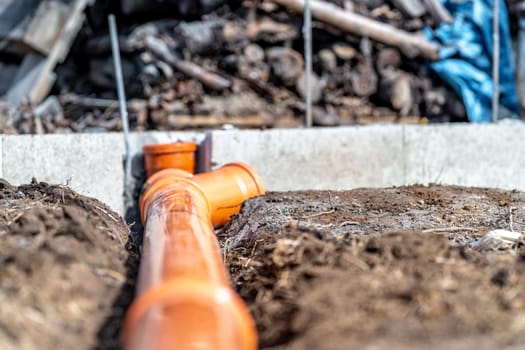 orange PVC plastic pipes on the construction site.