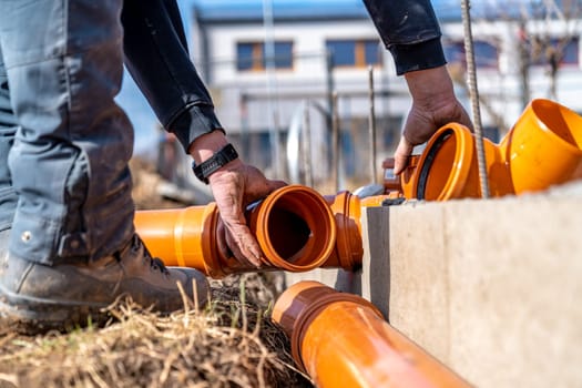 installation of a sewage plastic pipe during the construction of a house.