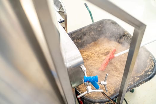 cleaning the boiler from residual malt after brewing beer in the brewery.