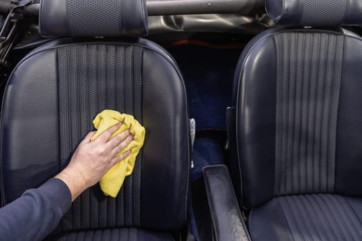 manual cleaning of the leather in the interior of the car with a micro towel.