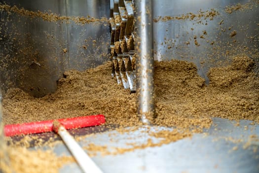 cleaning the boiler from residual malt after brewing beer in the brewery.