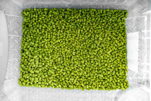 hops in green colored granules for the production of beer in a brewery. High quality photo