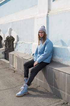 Portrait of a stylish woman in blue jacket. Spring outdoor portrait.