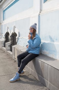 Portrait of a stylish woman in blue jacket. Spring outdoor portrait.