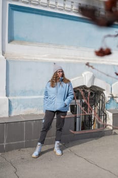 Portrait of a stylish woman in blue jacket. Spring outdoor portrait.