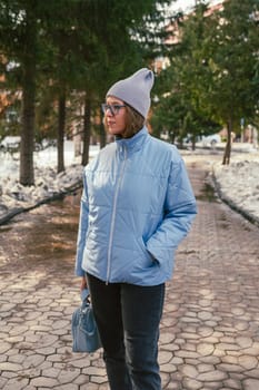 Portrait of a stylish woman in blue jacket. Spring outdoor portrait.