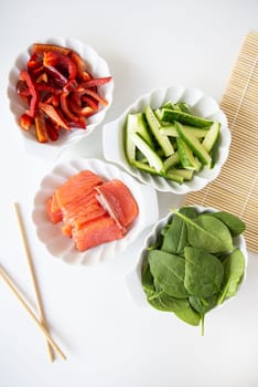 Preparation of all ingredients for cooking sushi seafood, vegetables, rice, nori, sticks, rug