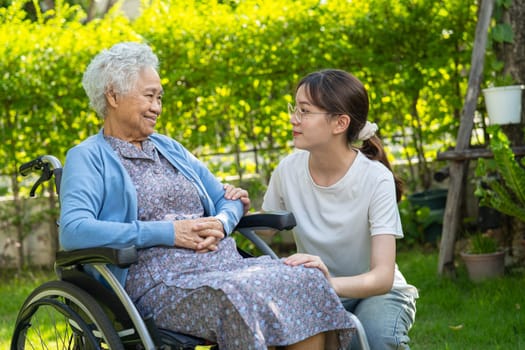 caregiver help and care Asian senior woman patient sitting on wheelchair at nursing hospital ward, healthy strong medical concept.