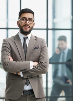 portrait of confident businessman with arms crossed