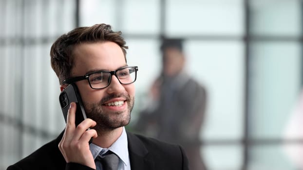 Close-up of a man in an office building talking on the phone,