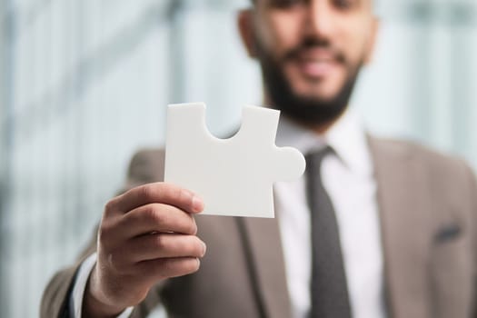 People holds in hand a jigsaw puzzle. Business solutions, success and strategy.