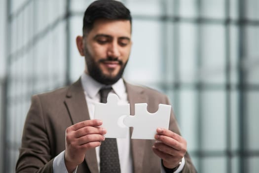 People holds in hand a jigsaw puzzle. Business solutions, success and strategy.