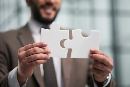 People holds in hand a jigsaw puzzle. Business solutions, success and strategy.