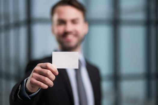 Businessman showing a blank business card, close-up
