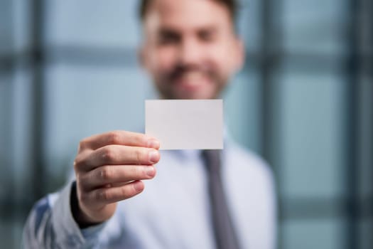 Man's hand showing business card - closeup shot