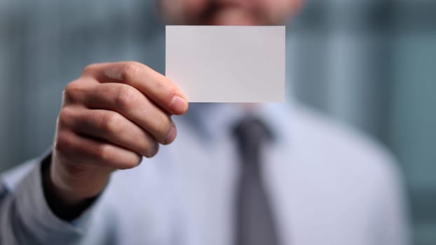 Portrait of serious confident smart modern investor banker executive boss manager freelancer showing card