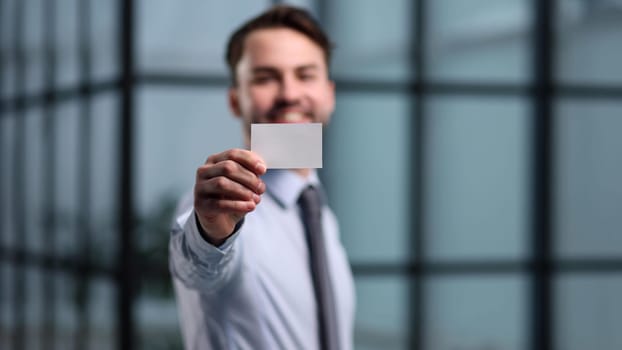 Portrait of serious confident smart modern investor banker executive boss manager freelancer showing card