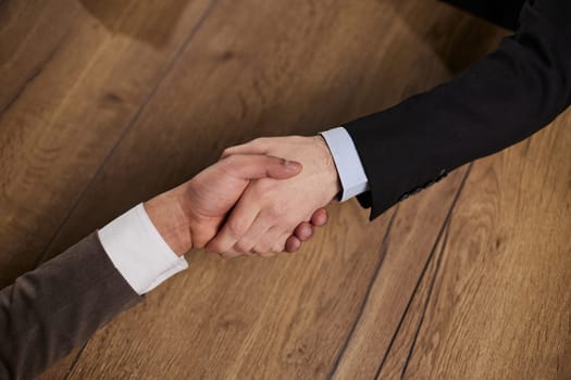 business people handshake over wooden table. businessmen agreement and partnership concept.