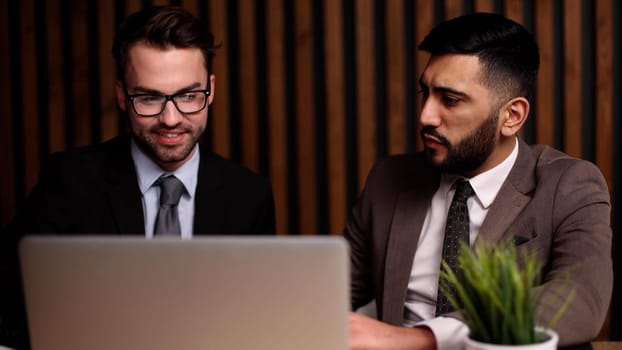 Business man talking with his colleague in the office at the table