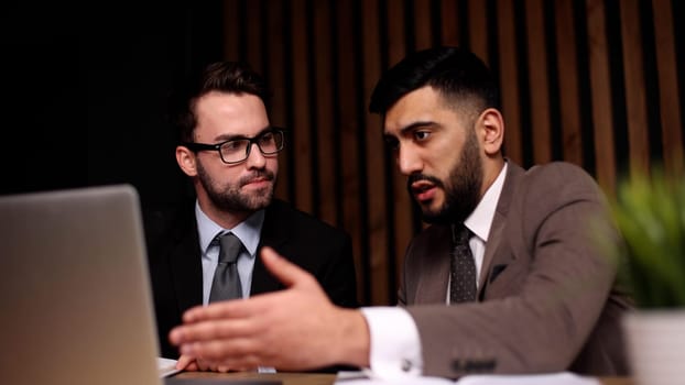 Business man having a discussion with his colleague in an office