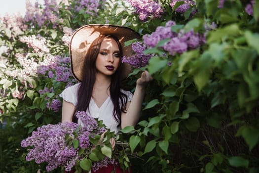 A fashionable girl with dark hair, a spring portrait in lilac tones in summer. Bright professional makeup