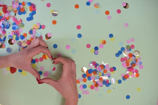 Heart formed by the hands of a young girl. High quality photo