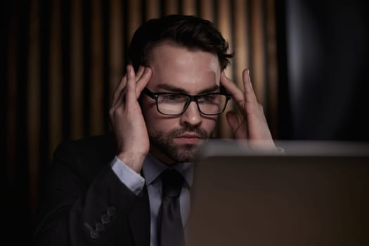 Worried businessman holding his head in his hands