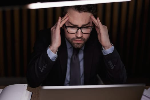 Worried businessman holding his head in his hands