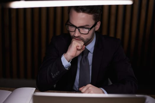 The man is thinking behind the laptop.