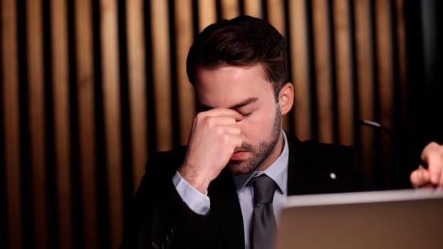 businessman with hands behind head resting in comfortable office.