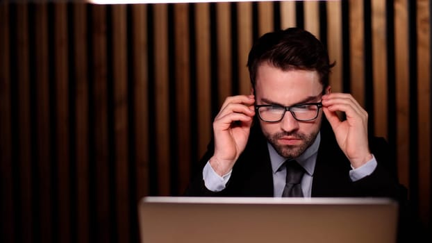 boss of the corporation looks into his laptop