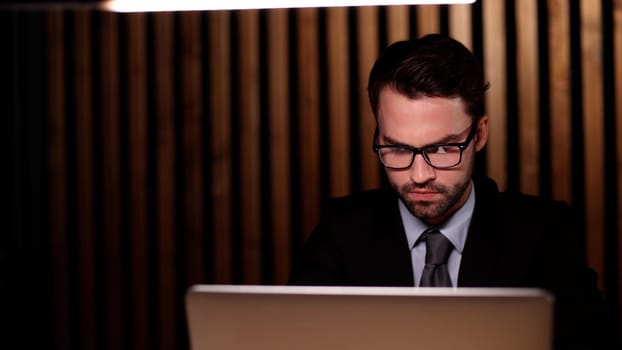boss of the corporation looks into his laptop