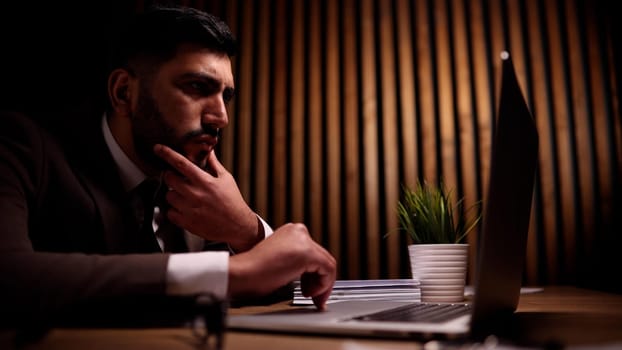 A young guy, a programmer or an entrepreneur i behind a laptop.