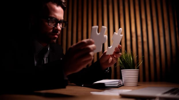 Attractive young guy solves a problem on the table in the office