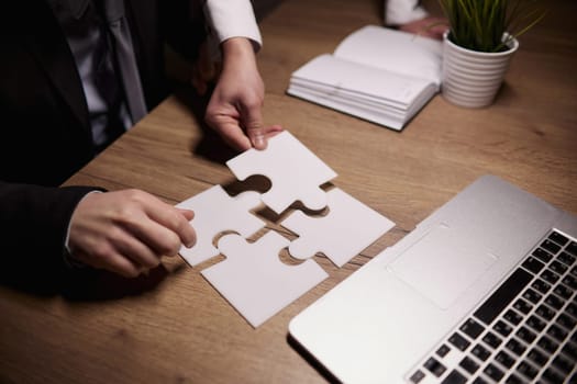 Crop close up of businessman hold pieces of jigsaw puzzle think of business problem solution or idea.