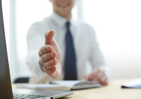Smiling businessman pleased to meet you at office