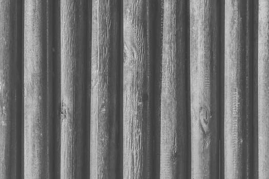 Large wood grey vertical logs fence plank texture board gray background.