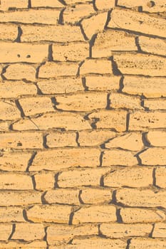 Sand color stone brick yellow vertical wall, modern texture ancient pattern background abstract.