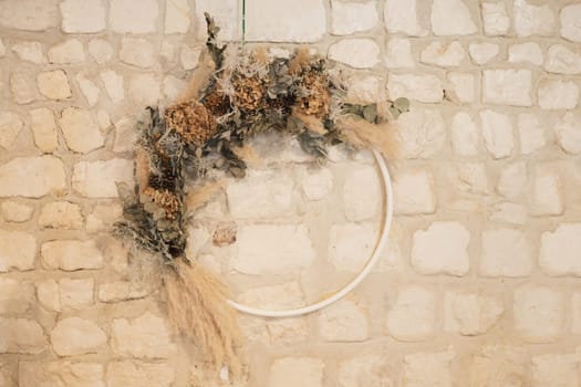 A wreath of dried hydrangea, pampas and eucalyptus at wedding