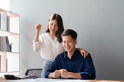 Family couple getting excited about success when they get email with excellent job offer looking at laptop computer with very excited face expressions.