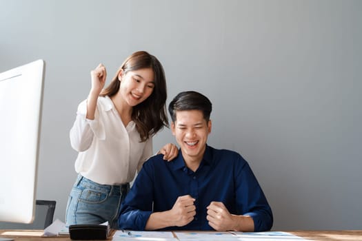 Family couple getting excited about success when they get email with excellent job offer looking at laptop computer with very excited face expressions.