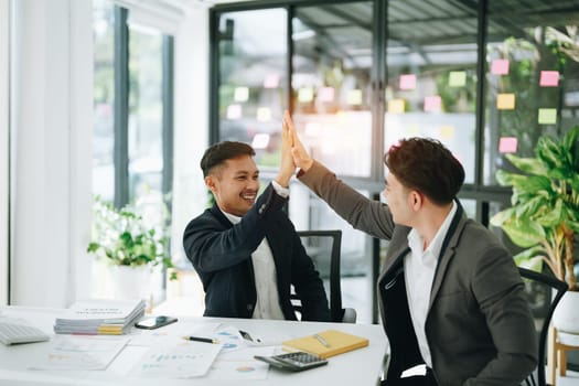 Give me five. managers employees join hands high celebrate common achievement. Two young men successful teammates friends greet each other with great job result.