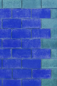 Blue and light blue paint on brick blocks urban color design wall texture background architecture.