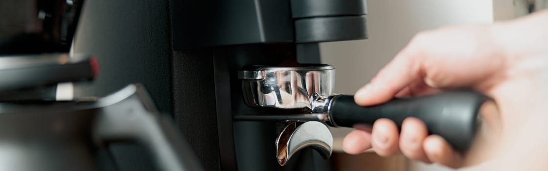 Process of pouring ground coffee into the filter from the coffee grinder