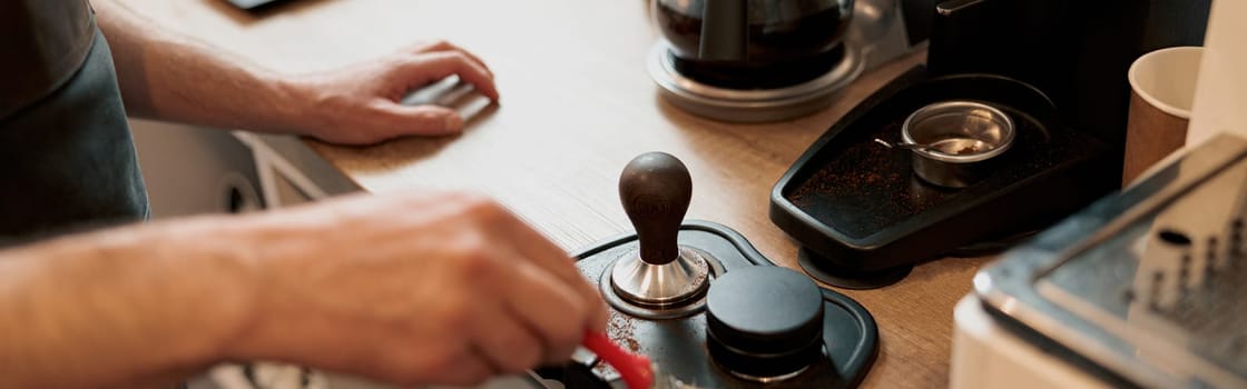 Male coffeeshop owner cleaning up counter for service to customer. Close up