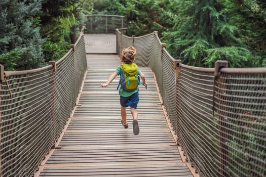 Boy tourist in Rope bridge in Yildiz Park. Besiktas, Istanbul, Turkey. Turkiye. Traveling with kids concept.