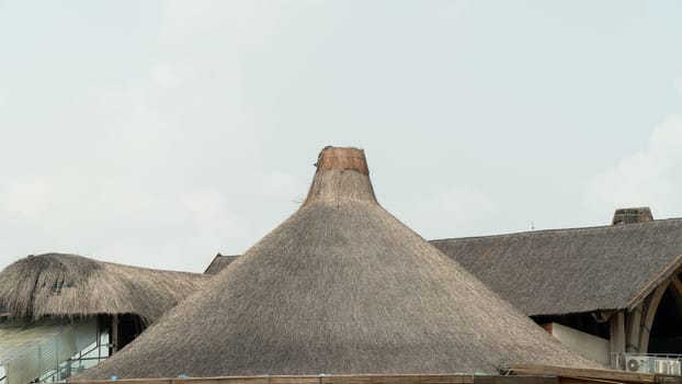 Thatched roof funnel against the sky. High quality photo