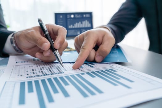 Closeup busy analyst team discussing financial data on digital dashboard, analyzing chart and graph using data science software display on a laptop screen. Business intelligence and Fintech. Fervent