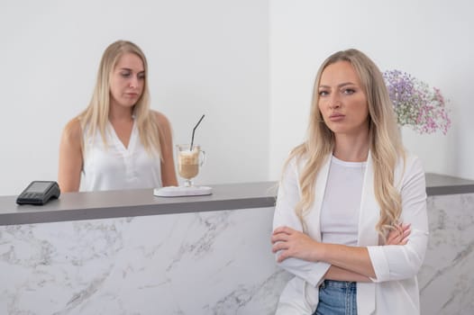 Dissatisfied client stands at the reception of a beauty salon