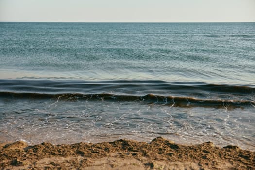 seascape with rolling waves on a calm, sunny day at sunset. High quality photo